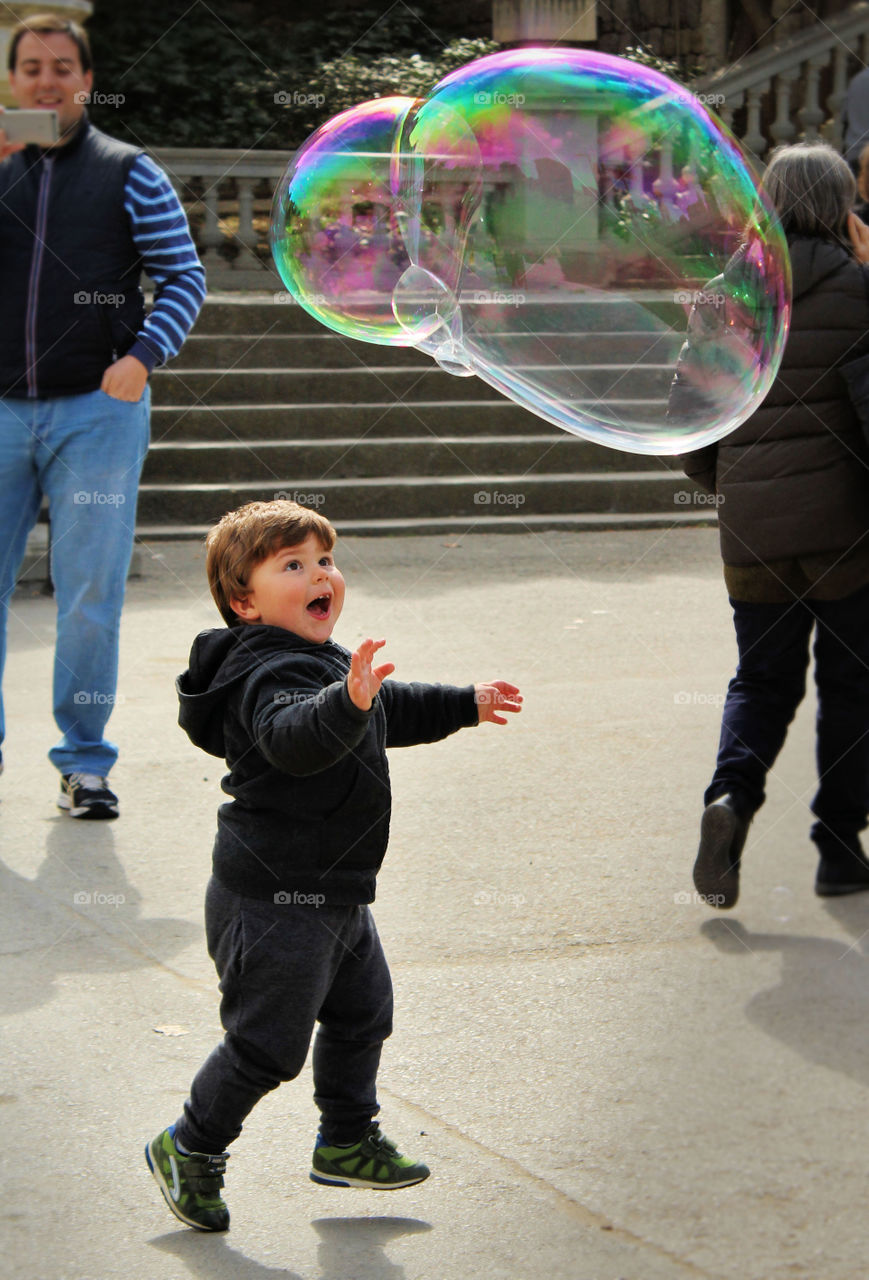 Boy having fun with soap bubble