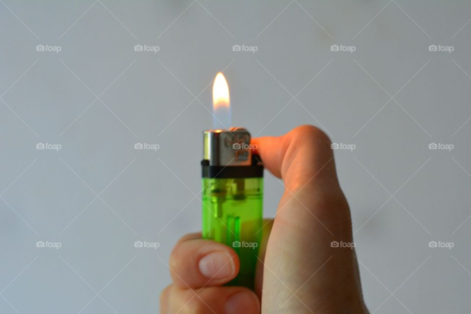 Close-up of a human hand holding cigarette lighter