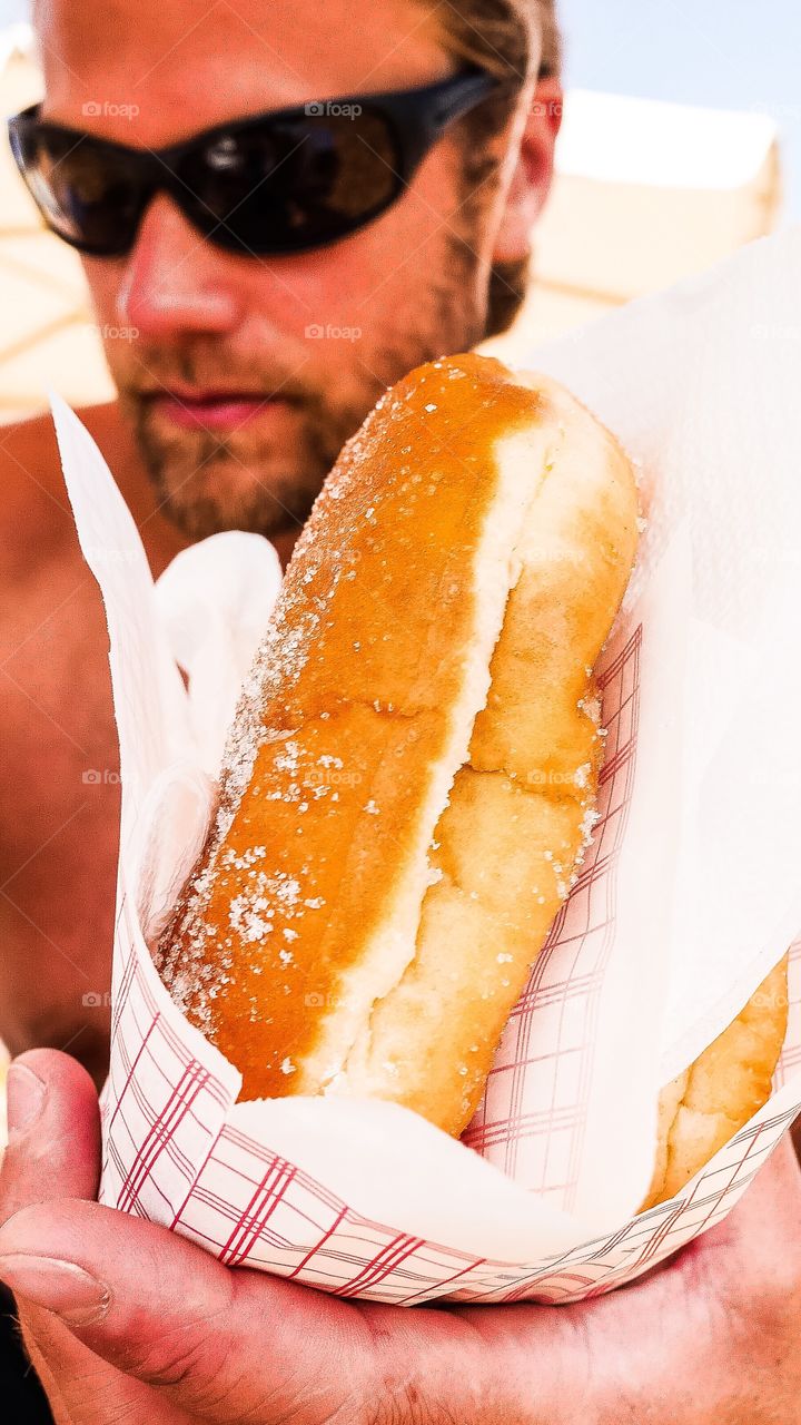Man holding cream bread