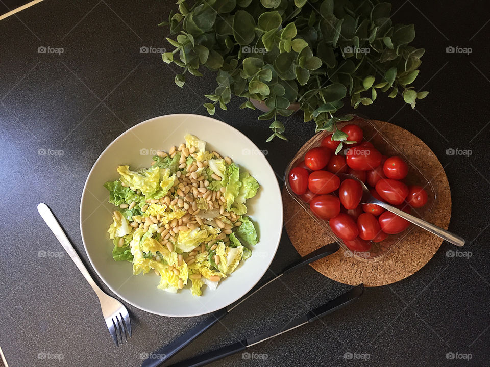 Flatlay iceberg lettuce with nuts and tomatoes cherry