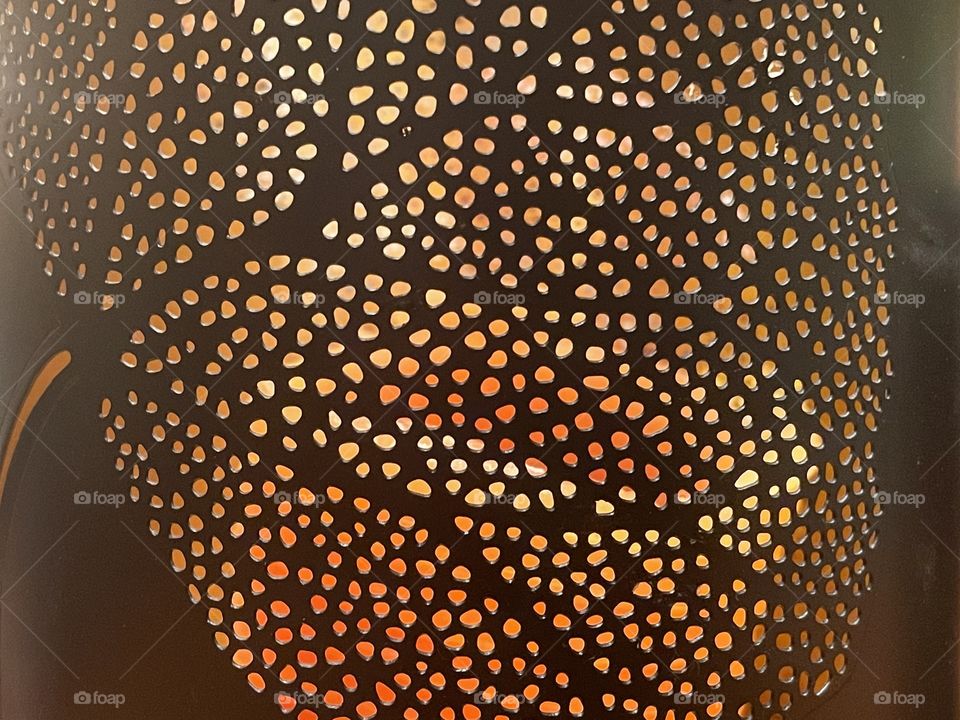 Perforated candle light shade in leaf pattern
