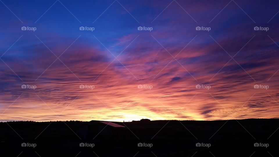 Multi-colored sunrise in the prairie sky