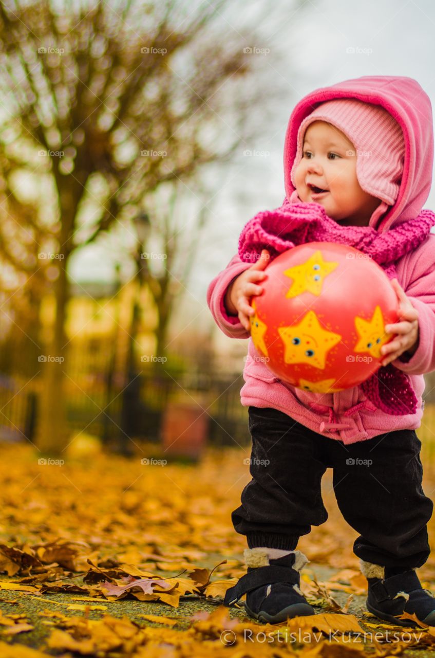 Cute boy playing with ball