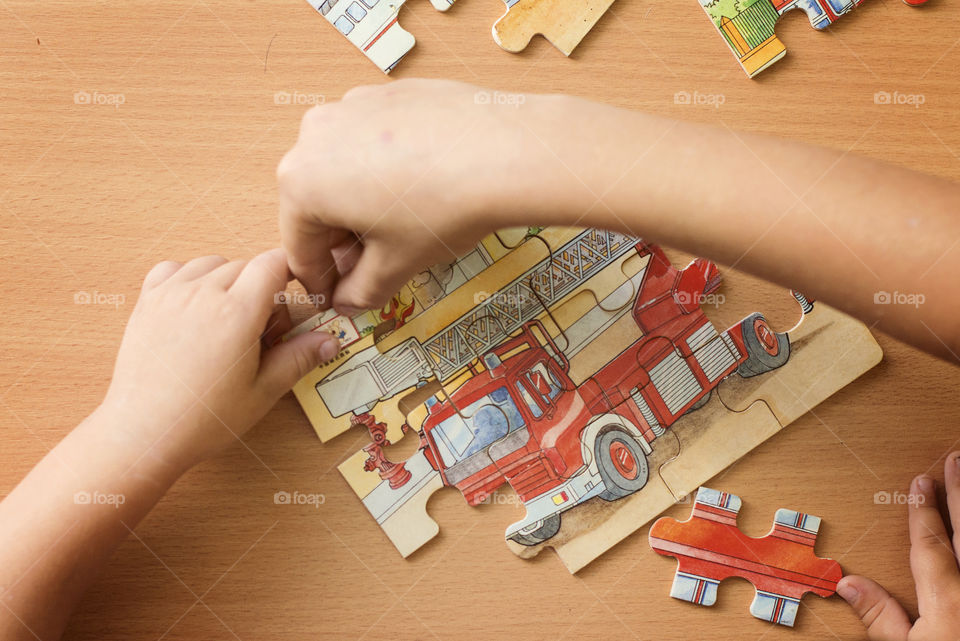 Directly above view of human hand with puzzle