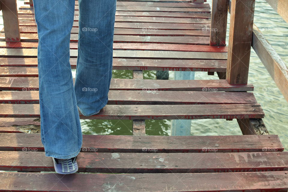 Walk forward on a wooden bridge.