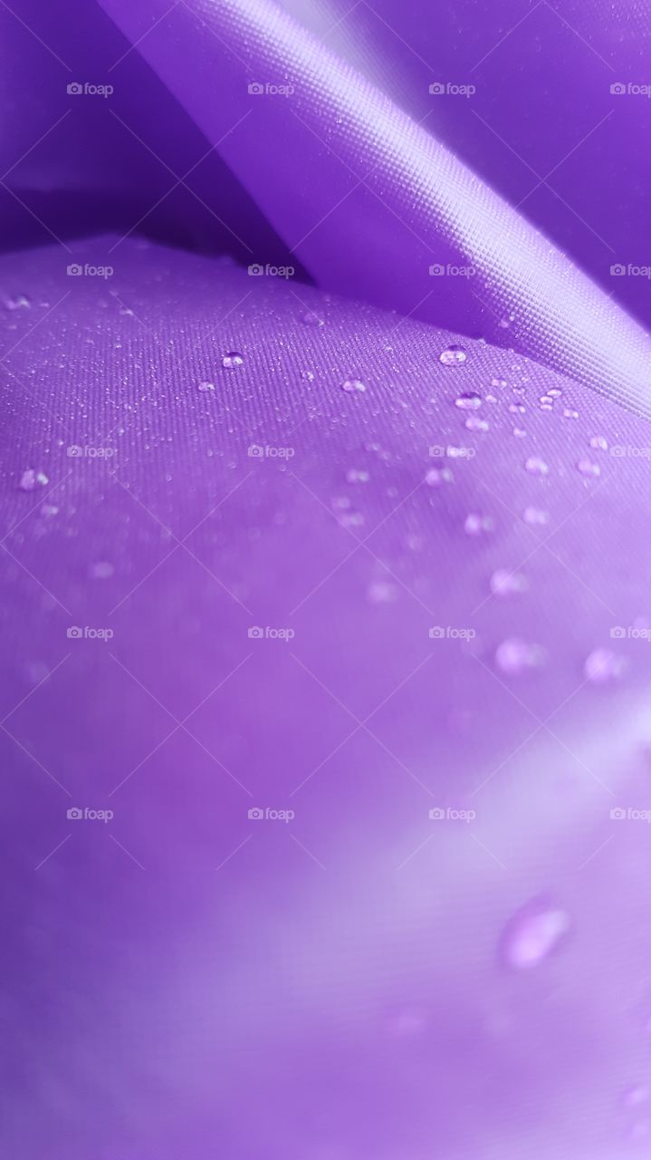Water drop on purple textile