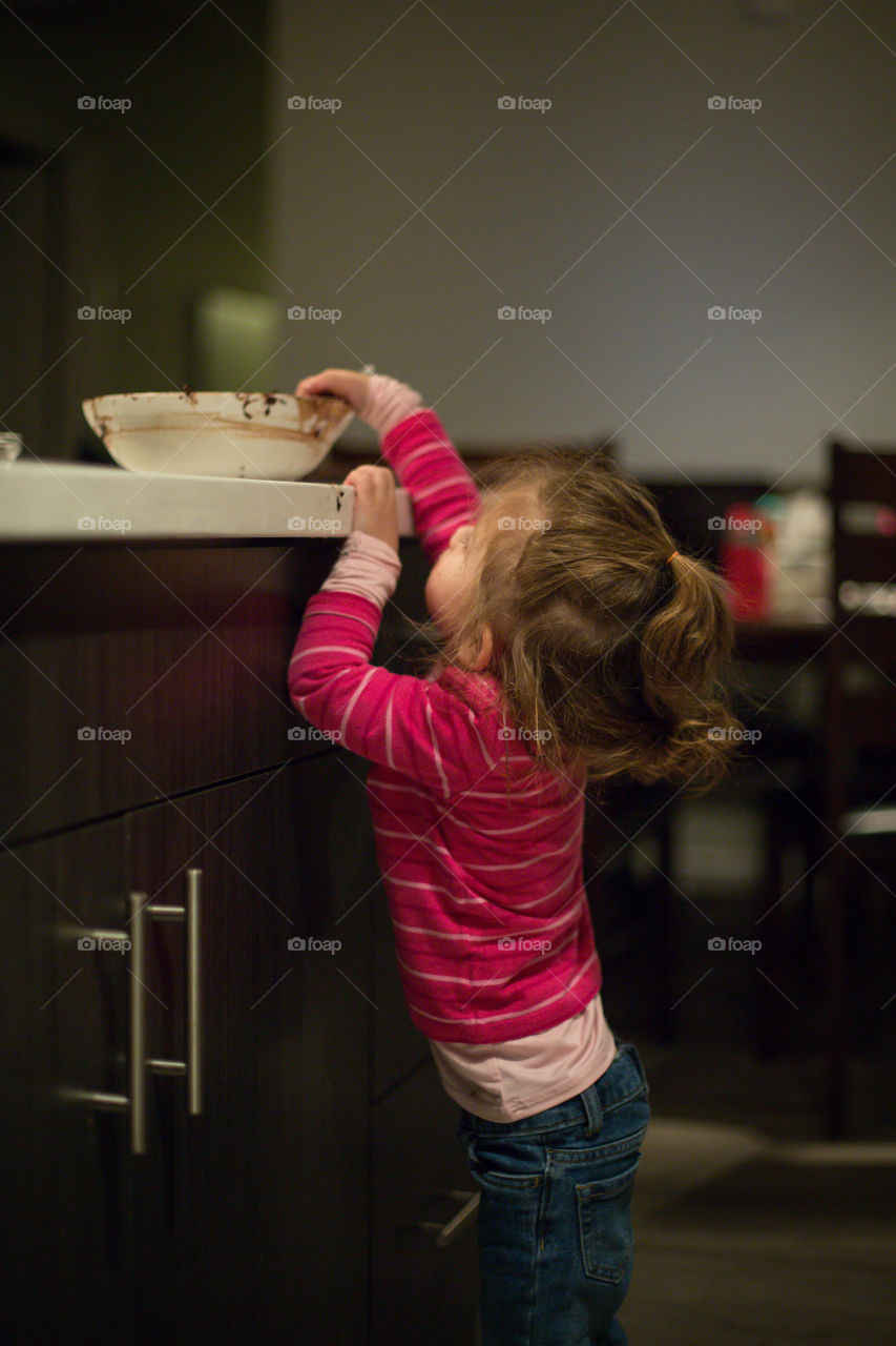 toddler sneaking a taste