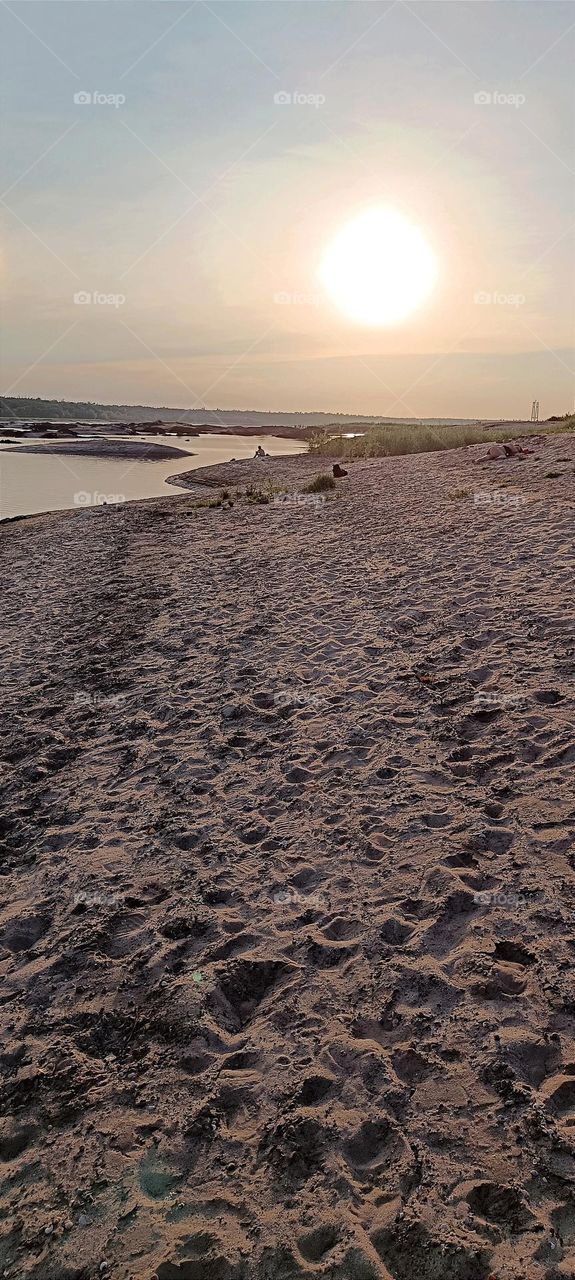 Evening on the beach by the river