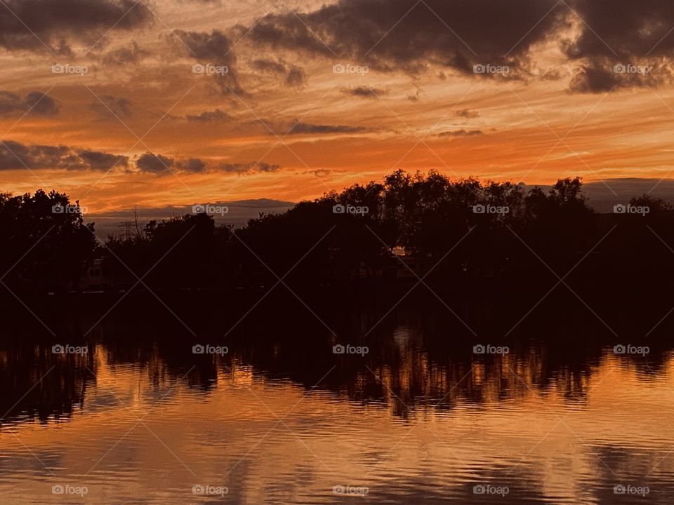 Massive Reflection of landscape on Lake Waters in conjunction with Sky Colors and Cloud formation. 