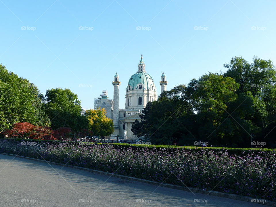 Gardening at Karlsplatz with Karlskirche in background in Vienna, Austria.