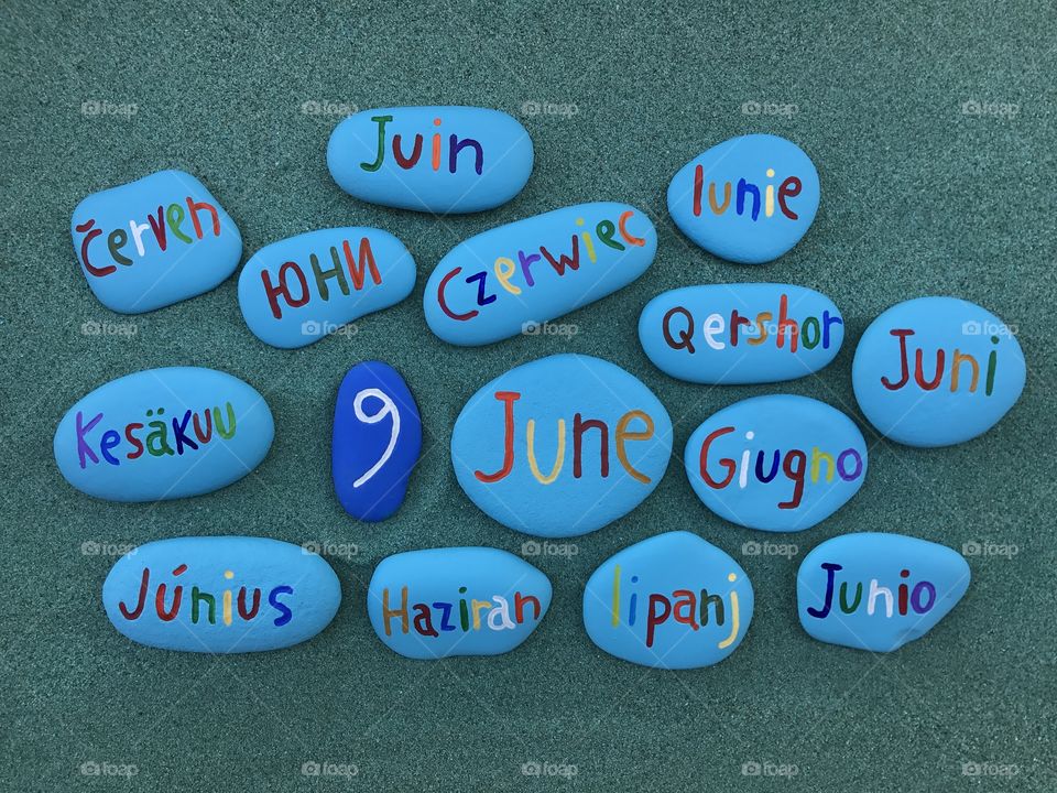 9 June, calendar date with colored stones over green sand