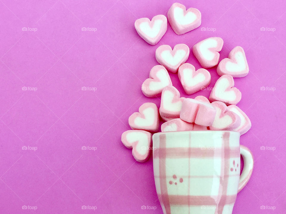 Marshmallows on pink background with copy space 