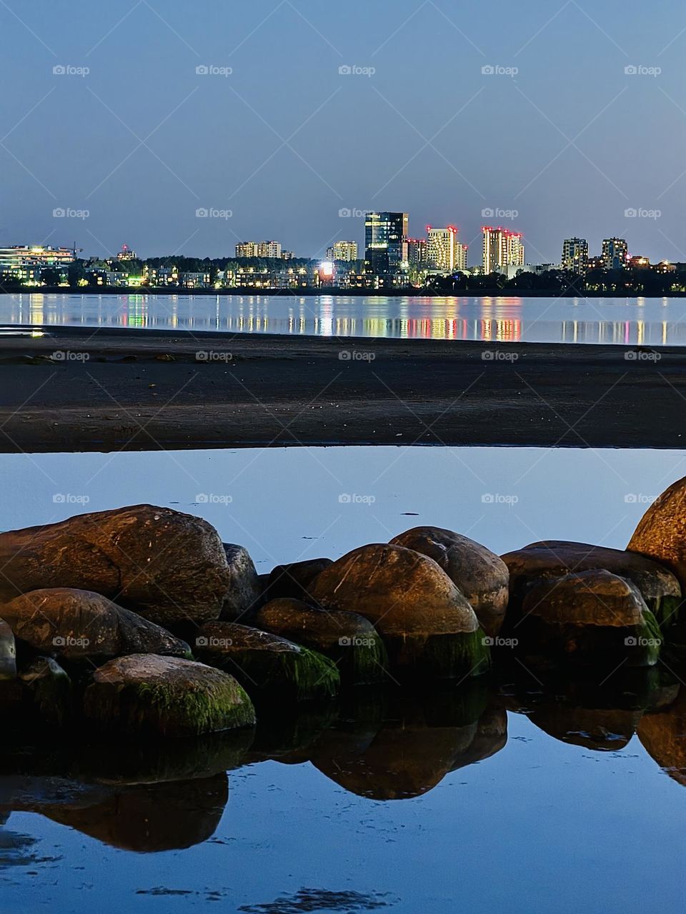 View of the city in the distance at dusk on the sea