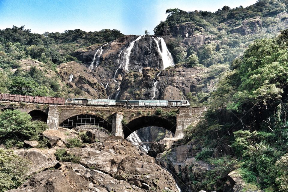 Konkan Railway waterfall bridge and train in view, India . Konkan Railway waterfall bridge and train in view, India 