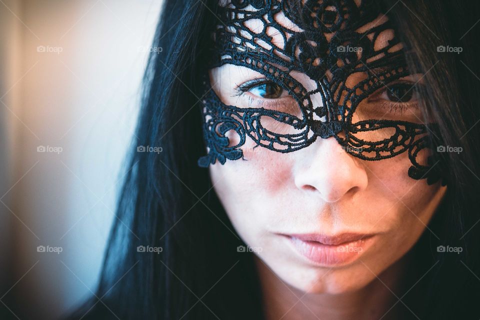 Close-up of woman face with lace mask