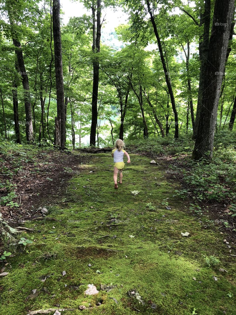 Excitedly racing through the woods to be the first kid in the lake this summer 