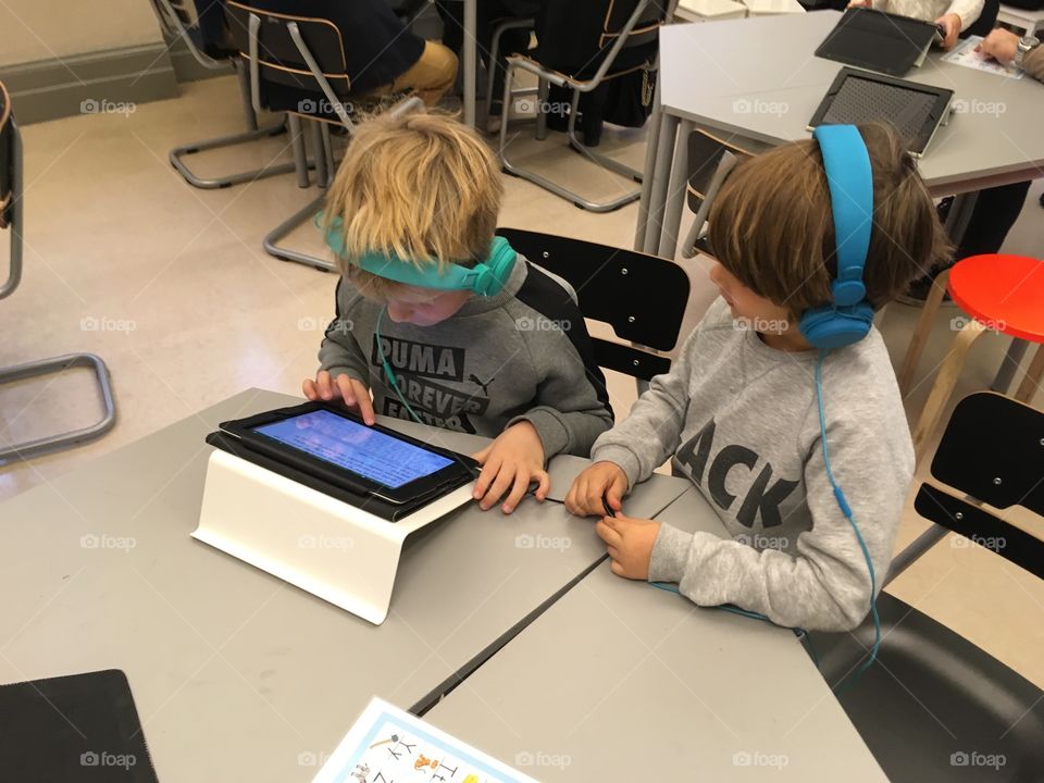 Two boys with iPad in classroom 