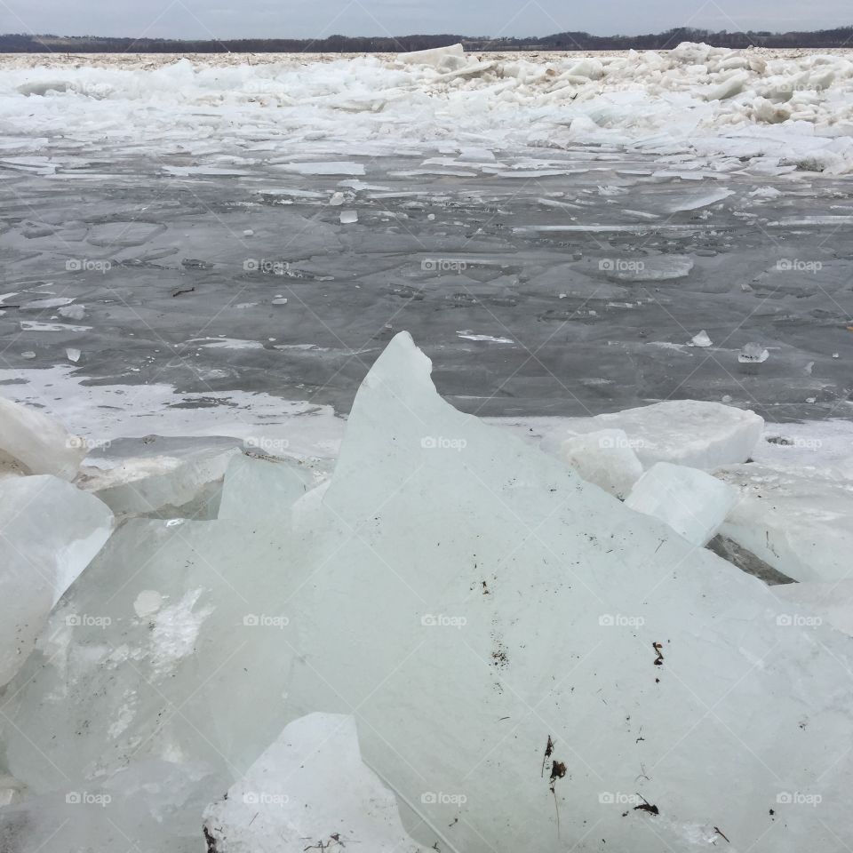 Huge chunk of ice so cold it looks cool blue and like a shark’s fun