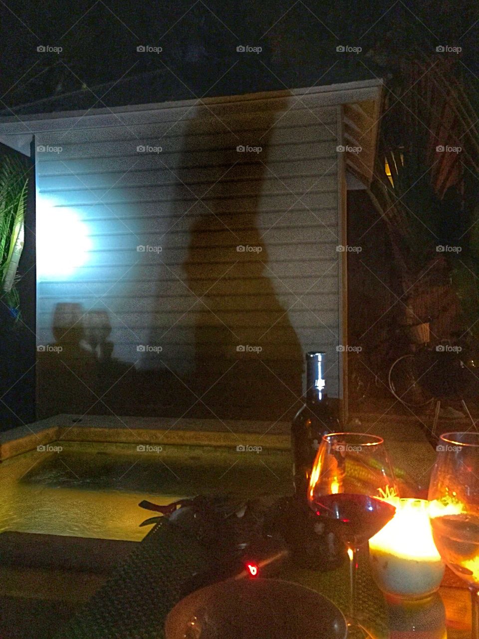 Candle Light Dinner. Nighttime shadow reflections poolside