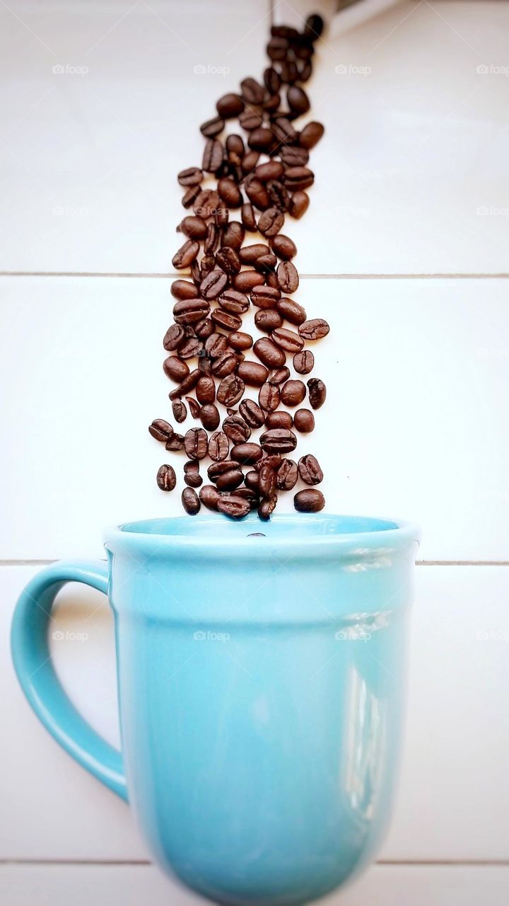 Close Up of Coffee Beans & a Blue Mug