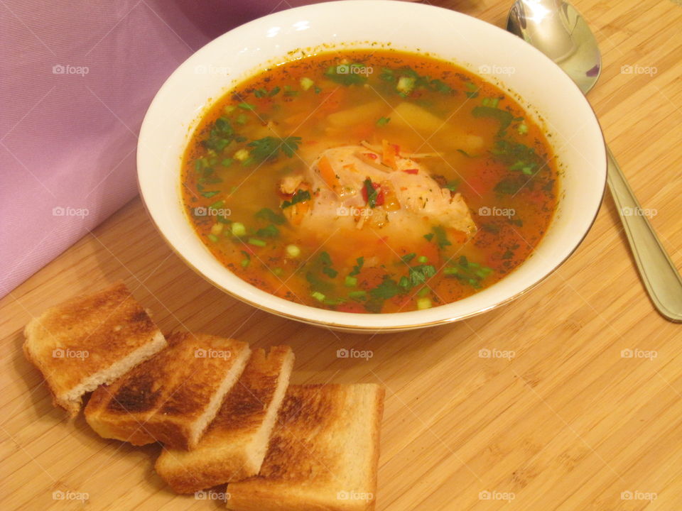 Chicken soup with toast bread