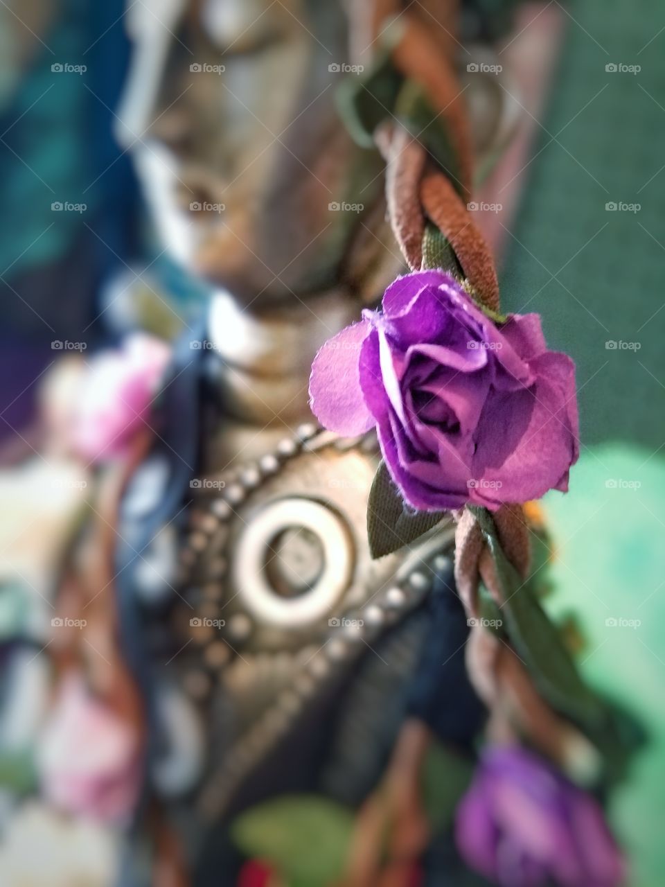 purple flower adorning a bronze statue