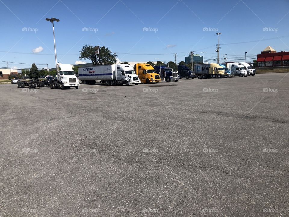 Truck stop, rest stop. Truckers resting. Trucks , trailers , sunny sky , blue sky. Driving