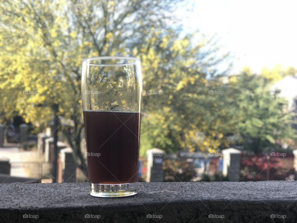 Cheers to the end of a long workday with a home brewed scotch ale while basking on balcony in the setting evening sun.