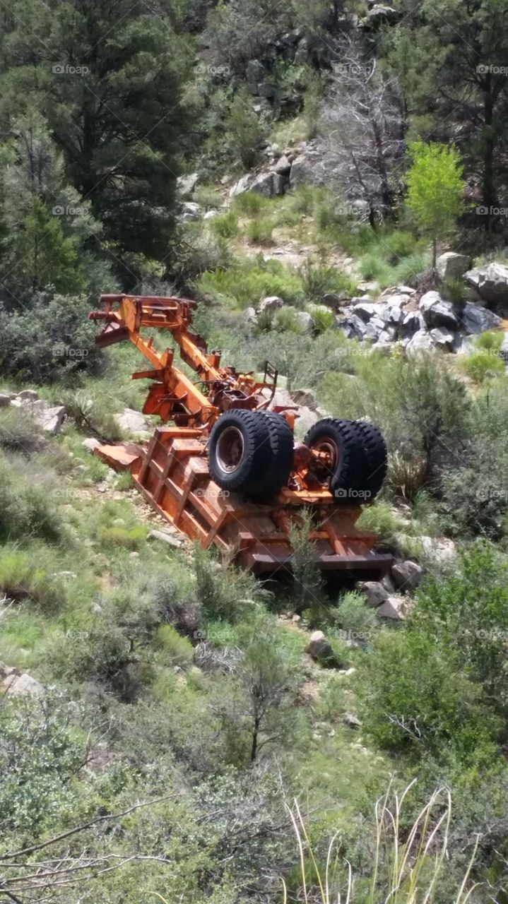 overturned hauling trailer that rolled down a hill in prescott.
