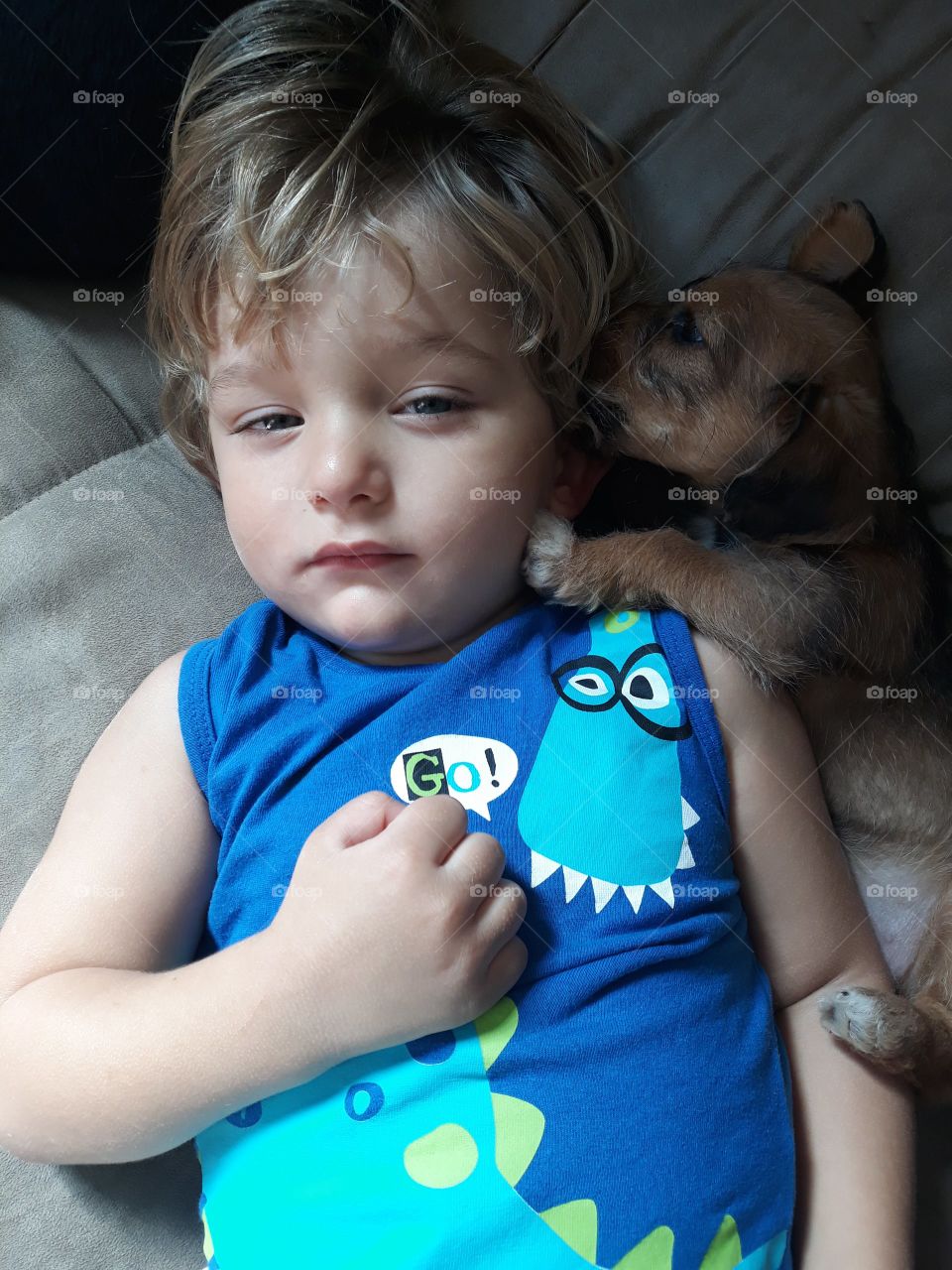 child lying with the puppy