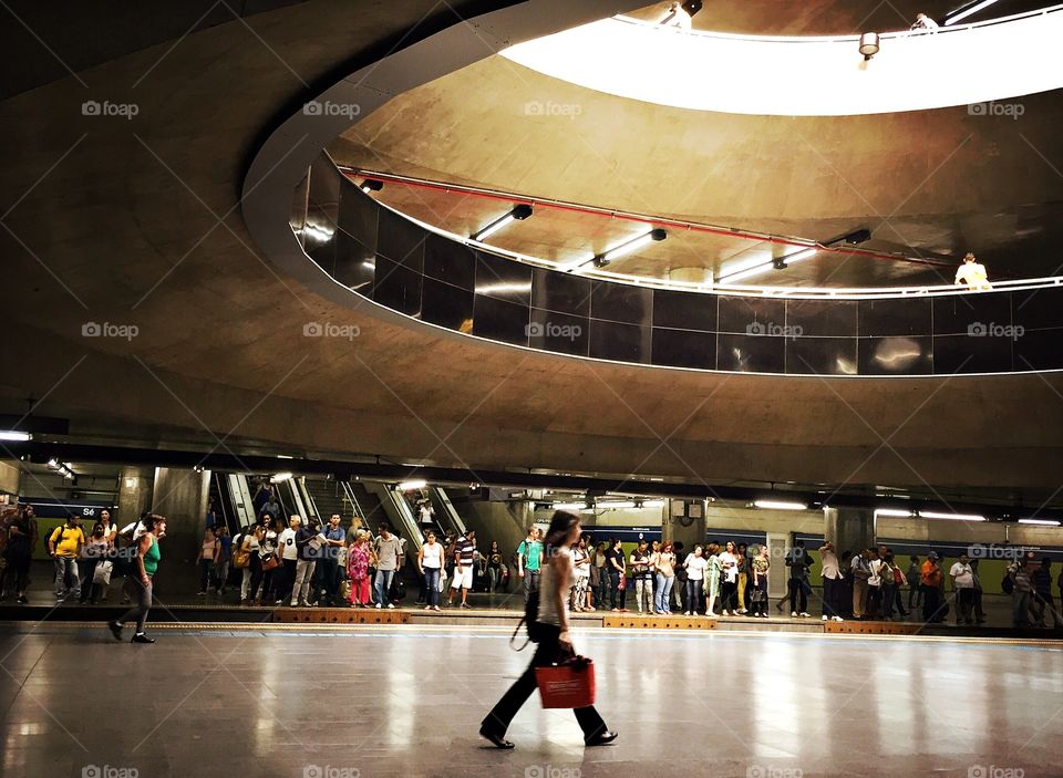 Woman walking in a illuminated subway station 