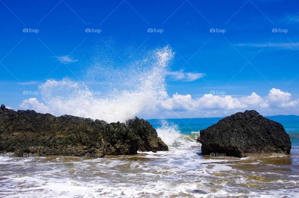 splash of sea water hitting the rocks