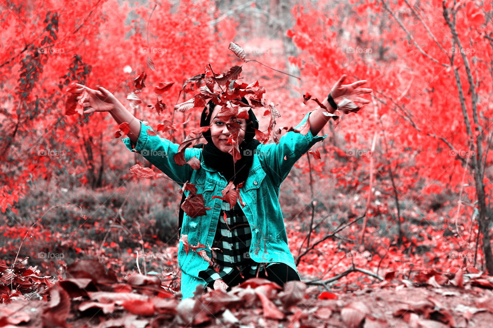 A girl with autumn leaves