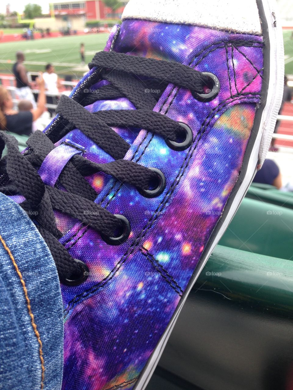 Football is out of this world. Close up of Girls Galaxy tennis shoe at football game