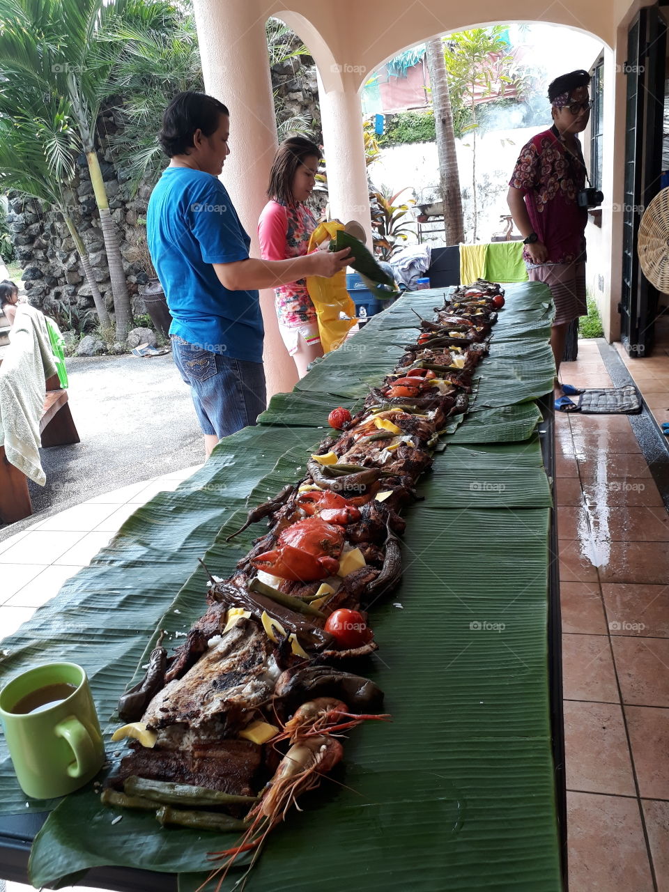 boodle fight only in the philippines with mix foods barbeque veggies seafood top on rice and voila!