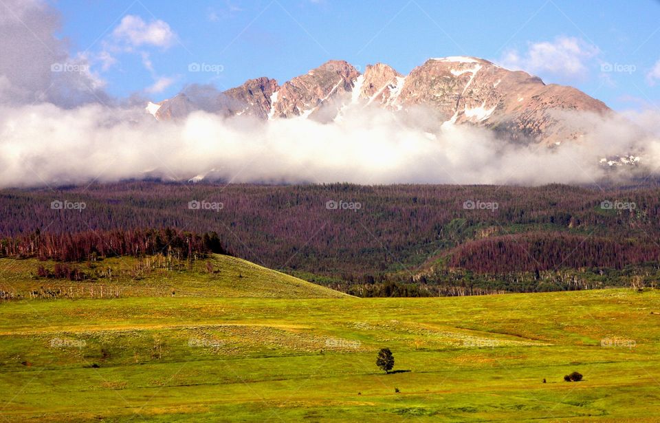 Clouds over snowy mountain