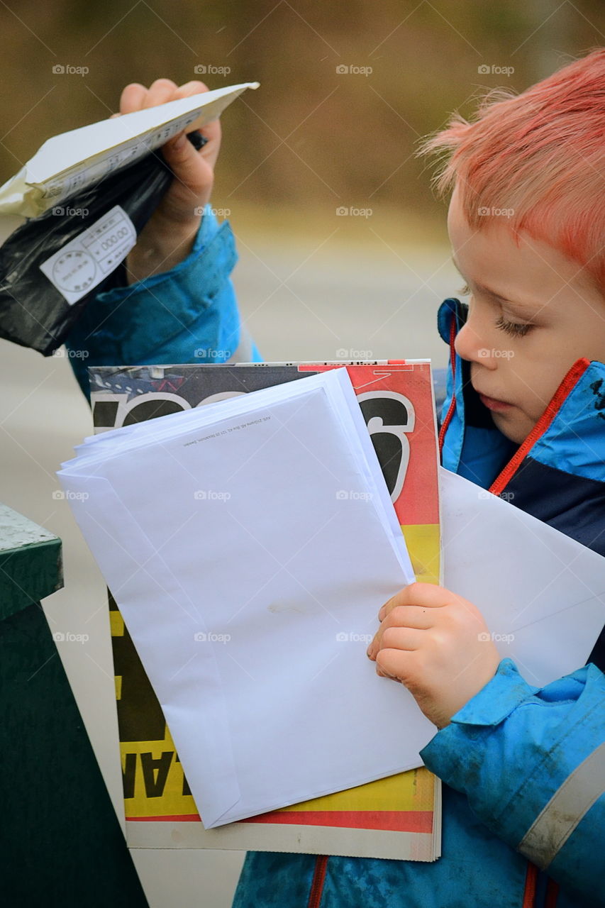 Boy getting letters from the mailbox