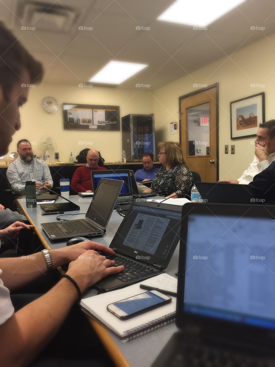 Group of people with laptops on desk at office