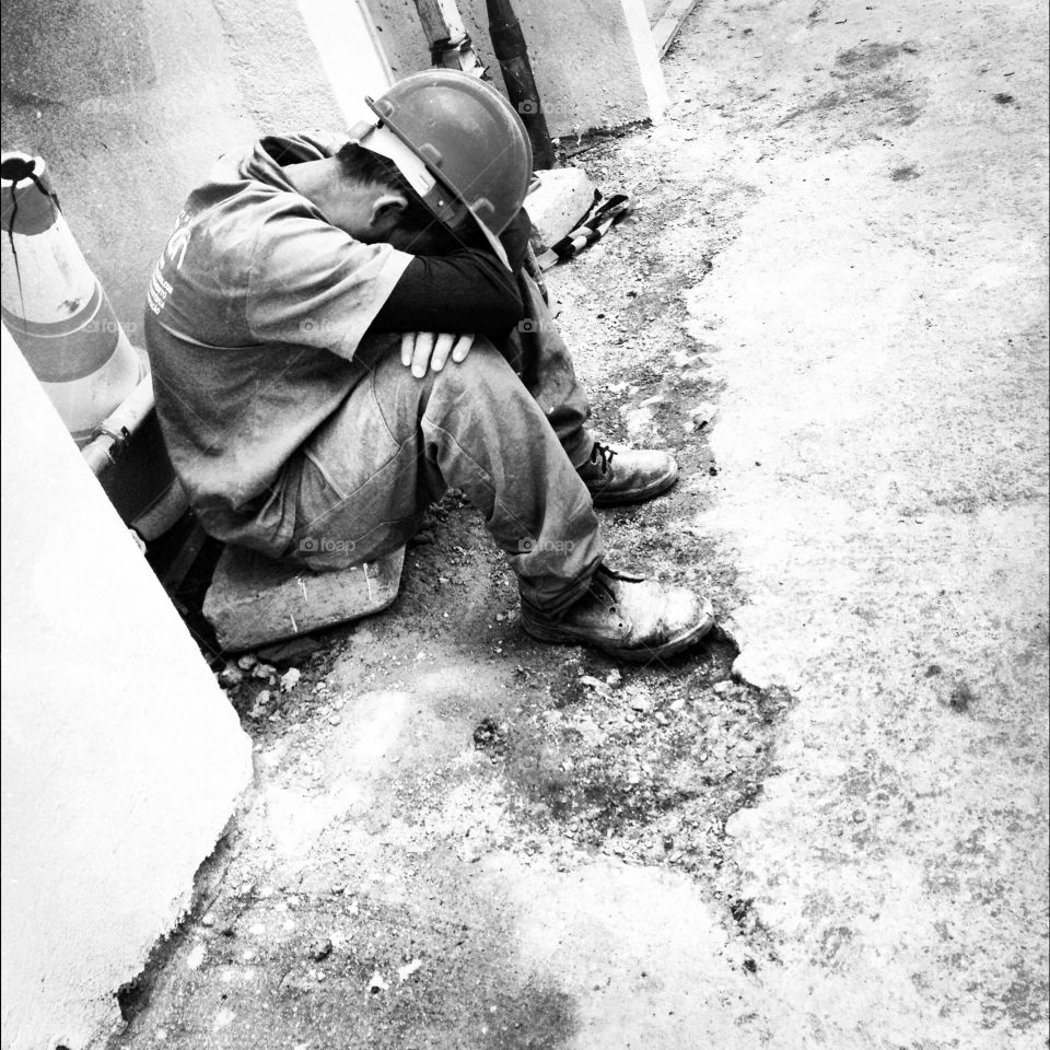 Working man in uniform rests sitting on the floor