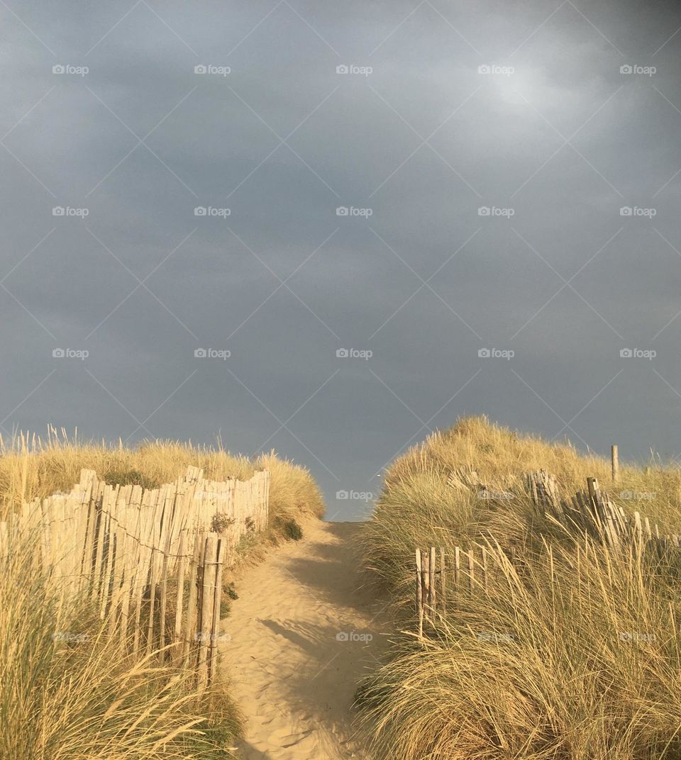 Hot days followed by welcomed storms. The beach picture - over sandy hills. Follow along the path to a beautiful British beach.