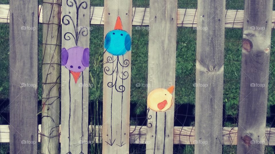 Bird Art on a picket fence.