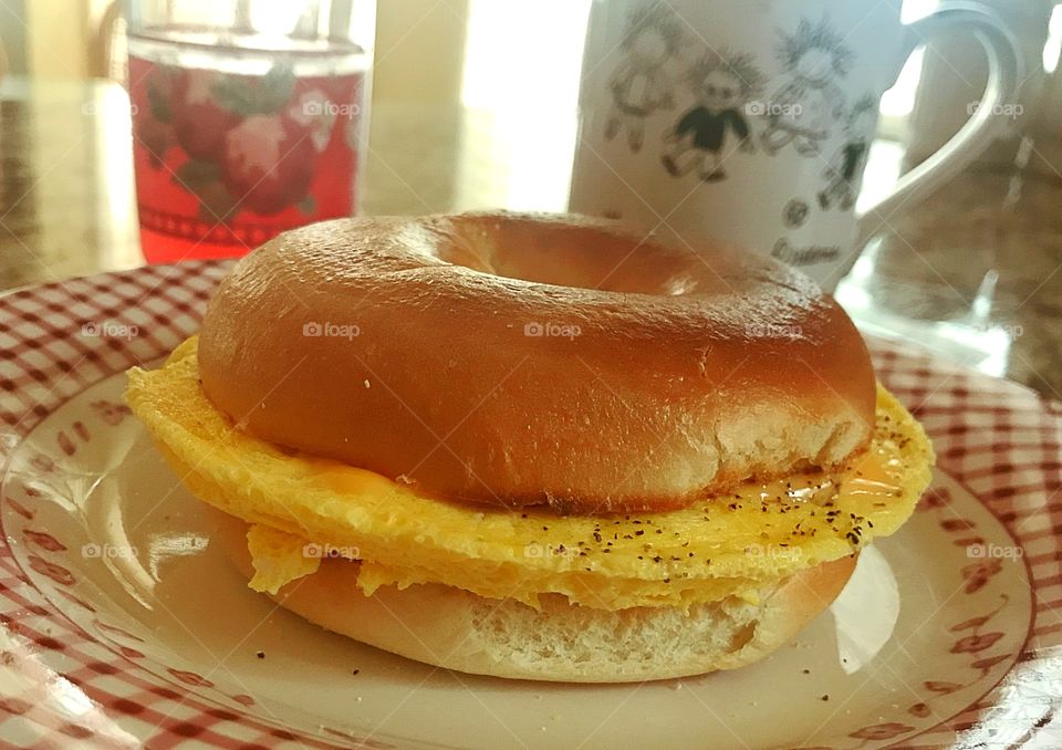 Scrambled eggs and cheese on a bagel breakfast 