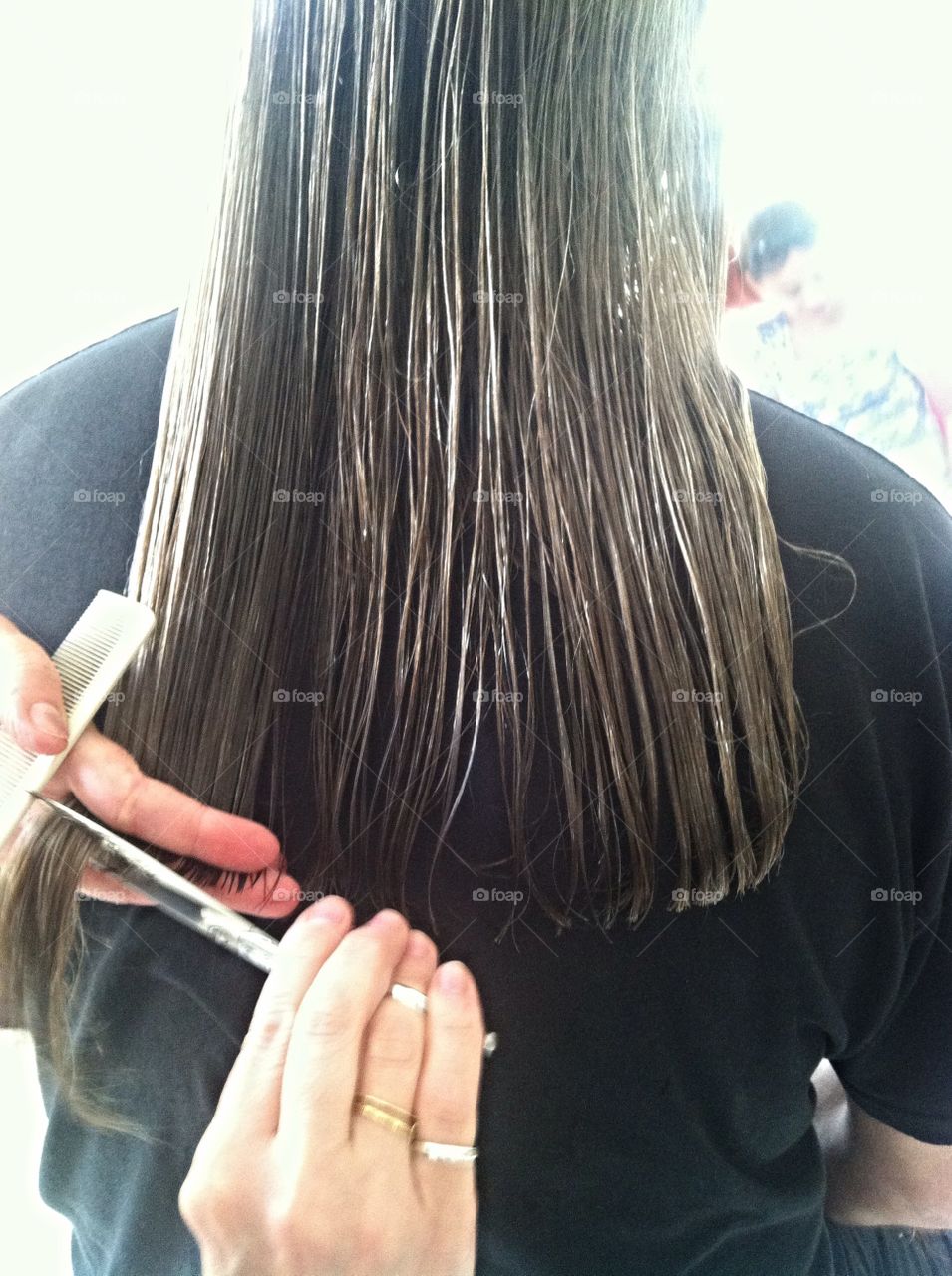 Haircut. Man with long hair getting a trim