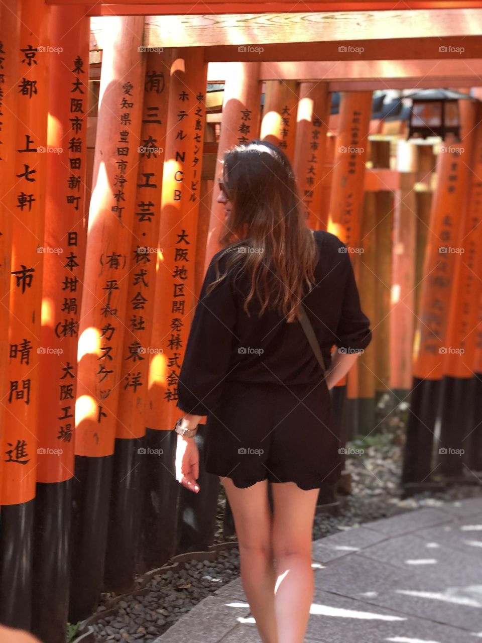 Walking through the gates that lead to holy places at shrine in Kyoto Japan. 
