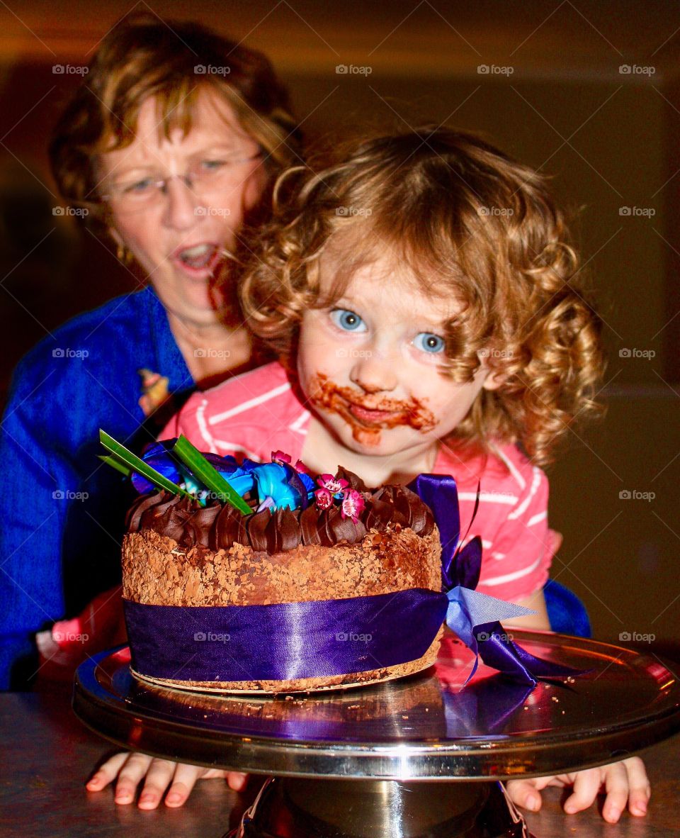 Naughty girl sticks mouth into birthday cake, grandma caught by surprise 