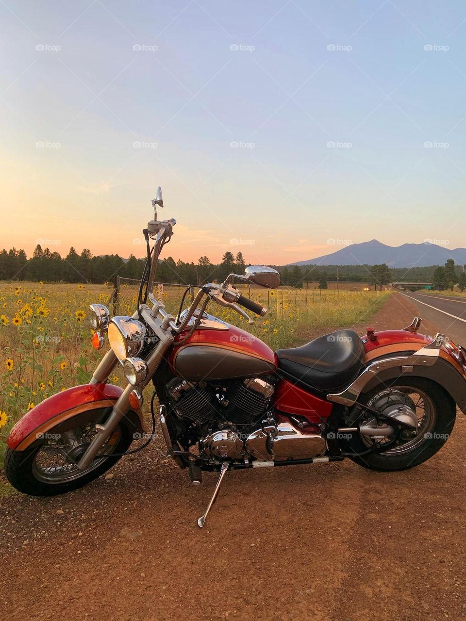 Sunset casts a warm glow on my son's motorcycle with the San Francisco peaks of Flagstaff Arizona in the background