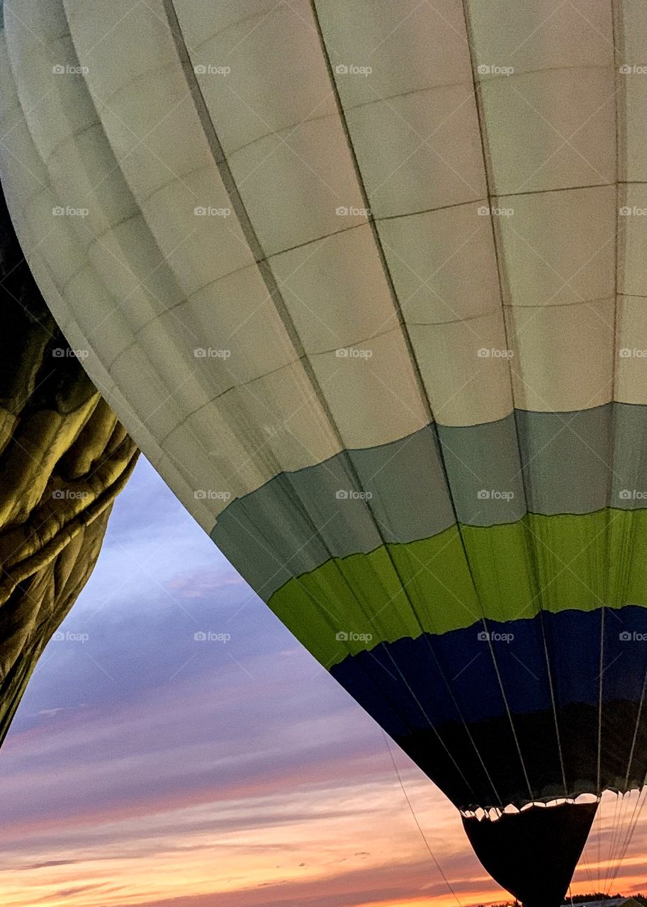 Two balloons crossing with pretty sky in background