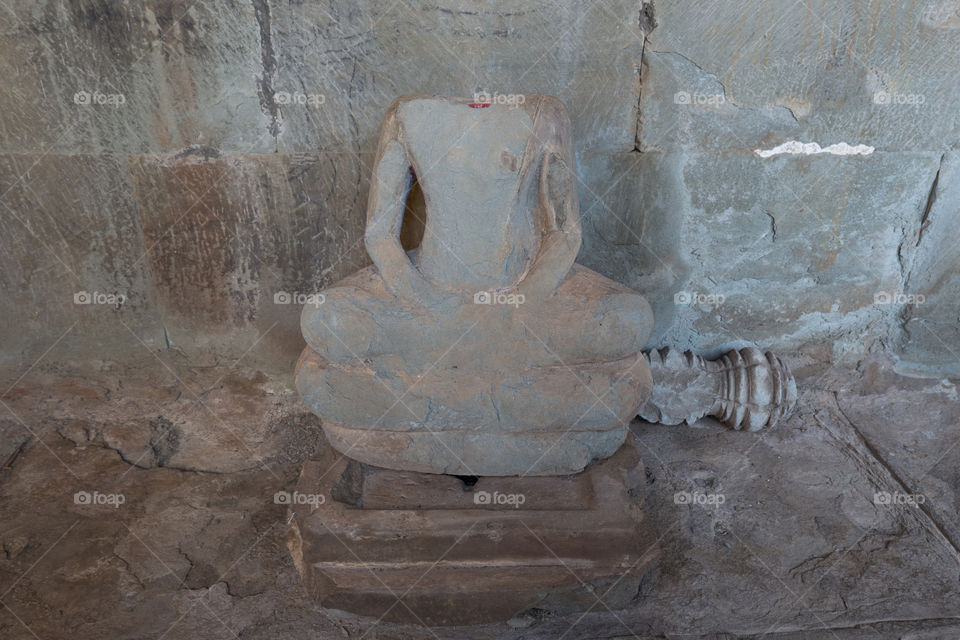 Old broken ruin buddha statue in Ankor Wat in Siem Reap Cambodia 