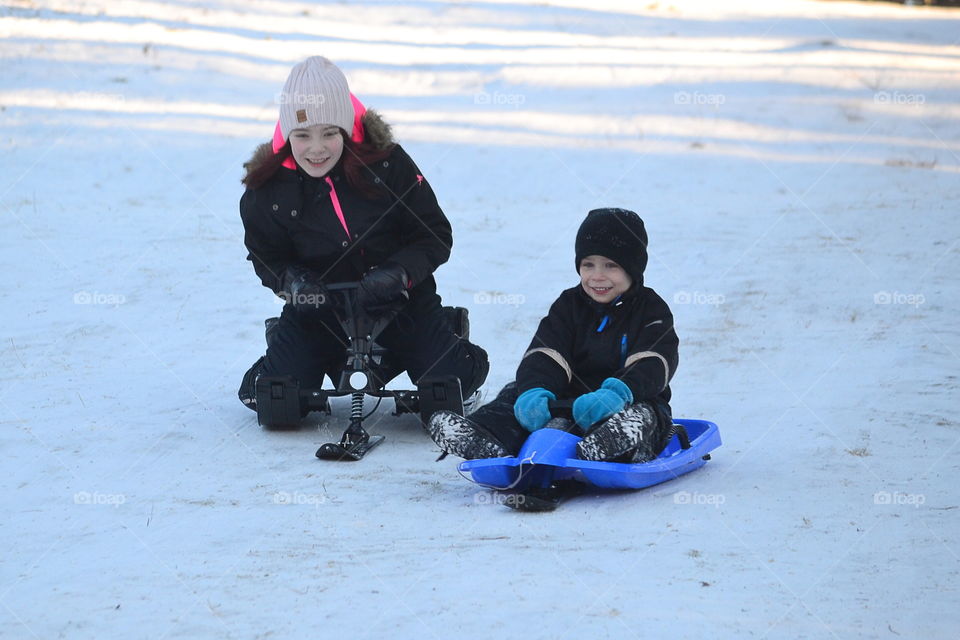 Two children with sleds