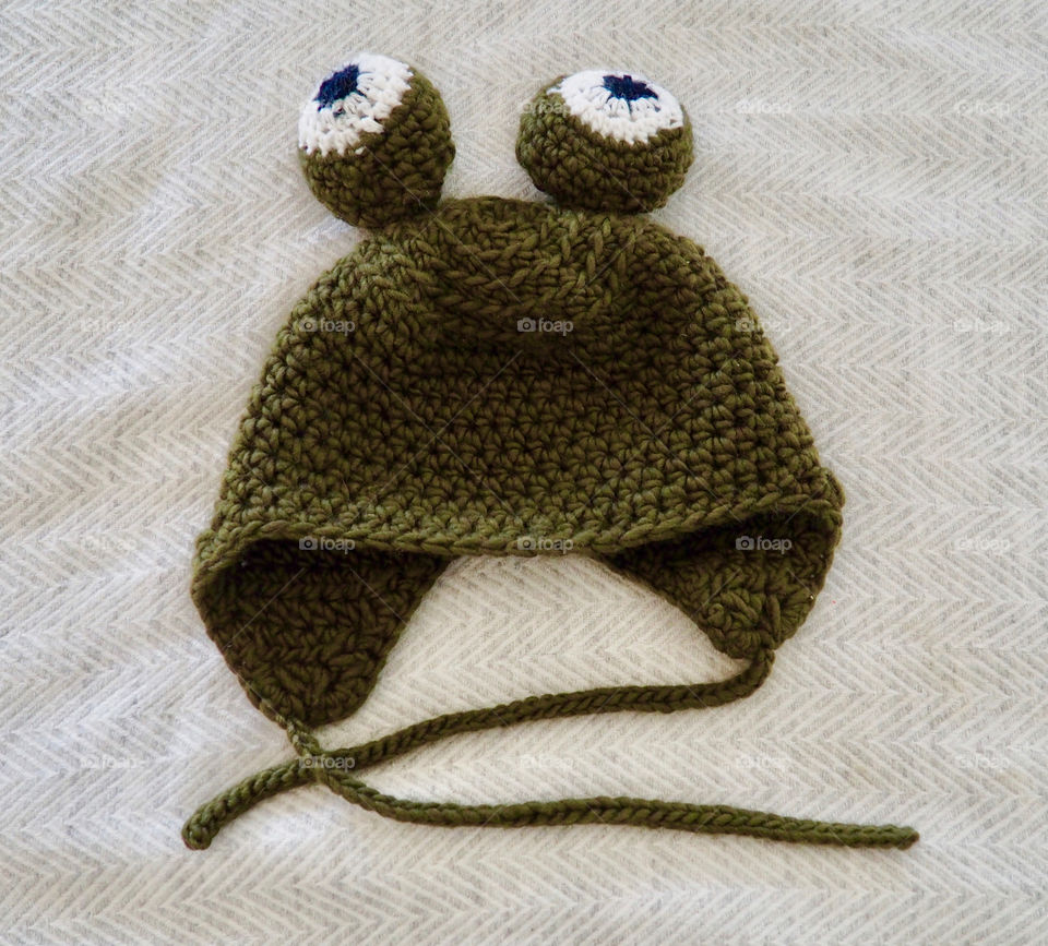 Hand made crochet green frog hat or bonnet with funny eyes.